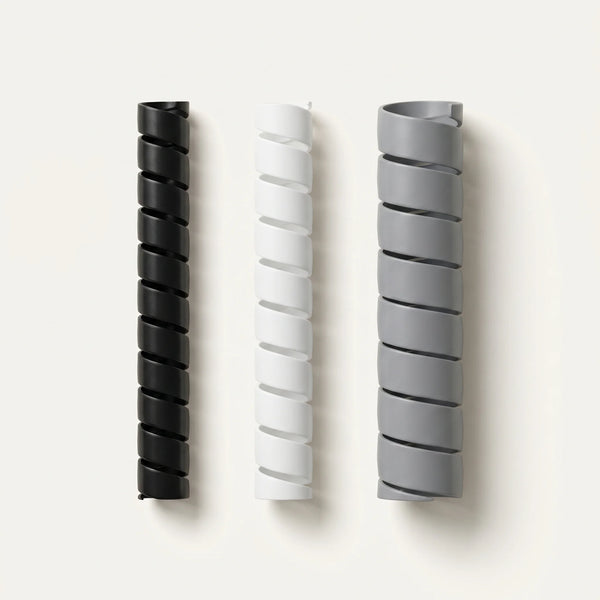 Gaine spiralée cache-câbles ProSetup en plastique flexible noir, enroulée, packshot sur fond clair